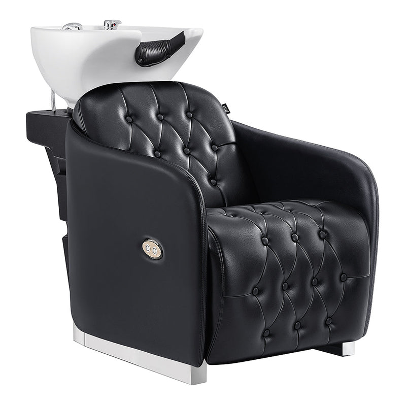 Black tufted salon chair with white basin on a white background