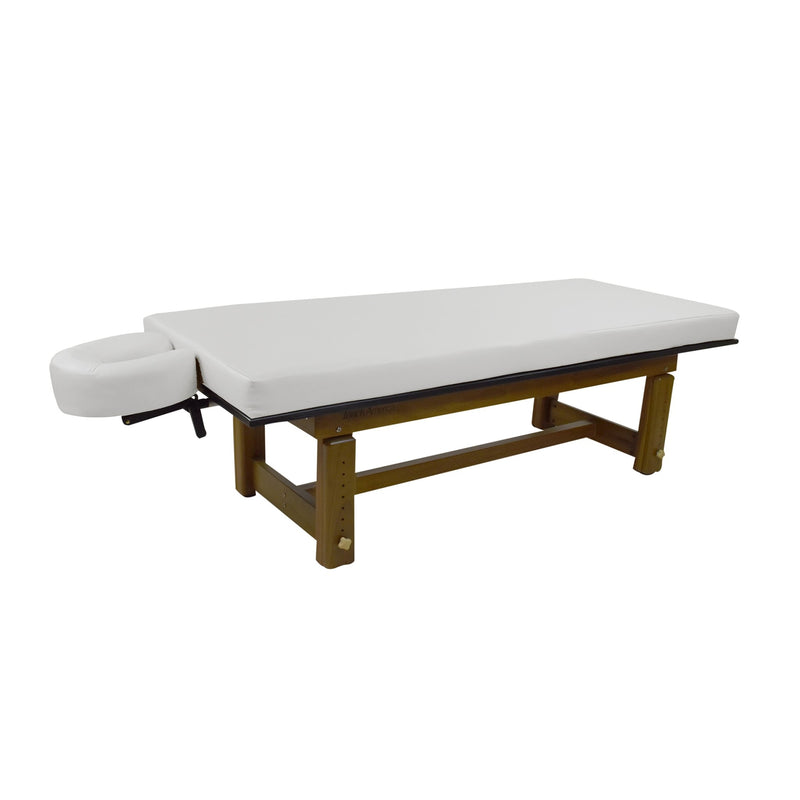 Solterra Teak Massage Table by TouchAmerica in white, with wooden legs and face cradle.